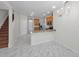 Kitchen features a breakfast bar with marble-patterned floors and stairs to second story at 10344 Tecoma Dr, Trinity, FL 34655