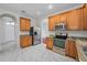 Kitchen with stainless steel appliances, granite countertops, and white marble-patterned tile floors at 10344 Tecoma Dr, Trinity, FL 34655