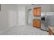 Kitchen with stainless steel refrigerator and white marble-patterned tile floors at 10344 Tecoma Dr, Trinity, FL 34655