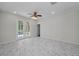 Bright living room featuring white marble floors, french doors, and a ceiling fan at 10344 Tecoma Dr, Trinity, FL 34655