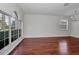 Spacious living room with hardwood floors, a large window, and neutral wall paint at 10344 Tecoma Dr, Trinity, FL 34655