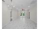 Spacious living room features marble-patterned tile floors and french doors to the backyard at 10344 Tecoma Dr, Trinity, FL 34655