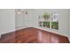 Inviting living room with hardwood floors, a large arched window, and natural light at 10344 Tecoma Dr, Trinity, FL 34655
