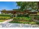 Exterior view of a park pavilion with landscaped hedges and accessible ramps at 10344 Tecoma Dr, Trinity, FL 34655