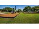 Vibrant playground with play structures set on a bed of mulch, surrounded by green lawns and shady trees at 10344 Tecoma Dr, Trinity, FL 34655