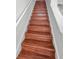 Wood staircase with white railings leads to the upper floors at 10344 Tecoma Dr, Trinity, FL 34655