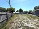 Spacious backyard featuring a wooden fence, vegetation, and potential for landscaping projects at 10431 Syringa Ct, Port Richey, FL 34668