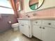 Well-lit bathroom featuring a vanity with sink, updated fixtures, and tile flooring at 10431 Syringa Ct, Port Richey, FL 34668