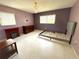 Bedroom with two windows, decorative fireplace, and chandelier at 10431 Syringa Ct, Port Richey, FL 34668