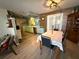 Eat-in kitchen and dining area that features modern lighting and access to the covered patio at 10431 Syringa Ct, Port Richey, FL 34668