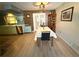 Cozy dining area featuring wood flooring, vintage decor, and a view of the kitchen at 10431 Syringa Ct, Port Richey, FL 34668
