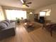 Inviting living room with neutral walls, hardwood floors, comfortable seating, and a ceiling fan at 10431 Syringa Ct, Port Richey, FL 34668
