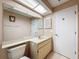 Bathroom with large mirror, marble countertop, and two entry doors at 11141 Sandtrap Dr # 11141, Port Richey, FL 34668