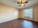 Bedroom with hardwood floors, neutral walls, and a window providing natural light at 11141 Sandtrap Dr # 11141, Port Richey, FL 34668