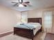 Cozy bedroom features a ceiling fan and a window with elegant, lace curtains at 11141 Sandtrap Dr # 11141, Port Richey, FL 34668