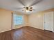 Empty bedroom featuring hardwood floors, a ceiling fan, and natural light from a window at 11141 Sandtrap Dr # 11141, Port Richey, FL 34668