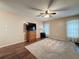 Spacious bedroom featuring hardwood floors, neutral walls, and a ceiling fan at 11141 Sandtrap Dr # 11141, Port Richey, FL 34668