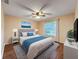 Bedroom featuring a full bed, blue accents, and wood flooring at 11141 Sandtrap Dr # 11141, Port Richey, FL 34668