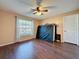Spacious bedroom with wood floors, ceiling fan, and natural light at 11141 Sandtrap Dr # 11141, Port Richey, FL 34668