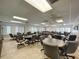 Bright community room with ample seating, tables, and fans perfect for social gatherings and activities at 11141 Sandtrap Dr # 11141, Port Richey, FL 34668