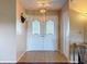 Bright foyer with decorative double doors, tile flooring, and a closet for storage at 11141 Sandtrap Dr # 11141, Port Richey, FL 34668