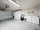 Well-lit garage featuring a washer, dryer, utility sink, storage cabinets, and an automatic door at 11141 Sandtrap Dr # 11141, Port Richey, FL 34668