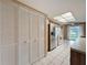 Bright kitchen featuring white tile flooring, stainless steel refrigerator and a pantry at 11141 Sandtrap Dr # 11141, Port Richey, FL 34668