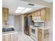 Kitchen features stainless steel appliances and white tile flooring at 11141 Sandtrap Dr # 11141, Port Richey, FL 34668