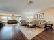 Spacious living room featuring wood floors, plush seating, and natural light at 11141 Sandtrap Dr # 11141, Port Richey, FL 34668