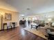 Open-concept living area featuring wood floors, dining area, and comfortable seating at 11141 Sandtrap Dr # 11141, Port Richey, FL 34668