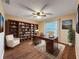 Home office showcasing built-in shelving, desk, chair, and wood flooring at 11141 Sandtrap Dr # 11141, Port Richey, FL 34668