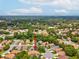 Aerial view with a red arrow showcases the home's location in a vibrant, tree-filled residential area at 11350 Copley Ct, Spring Hill, FL 34609