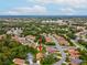 Aerial view of property with a red arrow, nestled within a lush neighborhood of mature trees at 11350 Copley Ct, Spring Hill, FL 34609