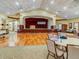 Spacious ballroom with a large wooden stage, ideal for events and community gatherings at 11350 Copley Ct, Spring Hill, FL 34609