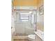 Tiled shower with glass door features a built-in seat at 11350 Copley Ct, Spring Hill, FL 34609