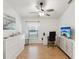 Bedroom with light walls, fan, television and desk area at 11350 Copley Ct, Spring Hill, FL 34609