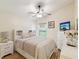 Cozy bedroom featuring a ceiling fan, window, and a white dresser at 11350 Copley Ct, Spring Hill, FL 34609