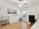 Bright bedroom with ceiling fan, murphy bed, and wood laminate flooring at 11350 Copley Ct, Spring Hill, FL 34609