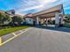 Exterior facade of community building surrounded by greenery and paved parking spots at 11350 Copley Ct, Spring Hill, FL 34609