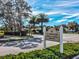 Signage for the Clubhouse Bar & Grill surrounded by lush landscaping on a sunny day at 11350 Copley Ct, Spring Hill, FL 34609