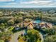 Aerial shot featuring a community clubhouse with a pool surrounded by lush trees and ample parking at 11350 Copley Ct, Spring Hill, FL 34609