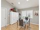 Cozy dining room features a glass table, modern chairs, a storage cabinet, and a window at 11350 Copley Ct, Spring Hill, FL 34609
