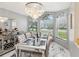 Elegant dining room with large windows, decorative chandelier, and mirrored accents at 11350 Copley Ct, Spring Hill, FL 34609