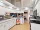 Bright kitchen features white cabinets, stainless steel appliances, granite countertops, and an eat-in bar at 11350 Copley Ct, Spring Hill, FL 34609