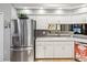 Bright kitchen features white cabinets, stainless steel appliances, granite countertops, and an eat-in bar at 11350 Copley Ct, Spring Hill, FL 34609