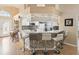Kitchen bar featuring marble backsplash, seating, and a view to the kitchen and eating nook at 11350 Copley Ct, Spring Hill, FL 34609