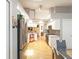 Open kitchen features white cabinets, stainless steel appliances, granite countertops, and leads to dining room at 11350 Copley Ct, Spring Hill, FL 34609