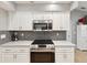 Updated kitchen featuring stainless steel appliances, granite countertops, and stylish backsplash at 11350 Copley Ct, Spring Hill, FL 34609