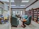 Well-stocked library featuring a cozy seating area and extensive collection for residents to enjoy at 11350 Copley Ct, Spring Hill, FL 34609