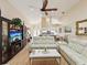 Bright living room with vaulted ceilings, modern furnishings and open concept to kitchen at 11350 Copley Ct, Spring Hill, FL 34609